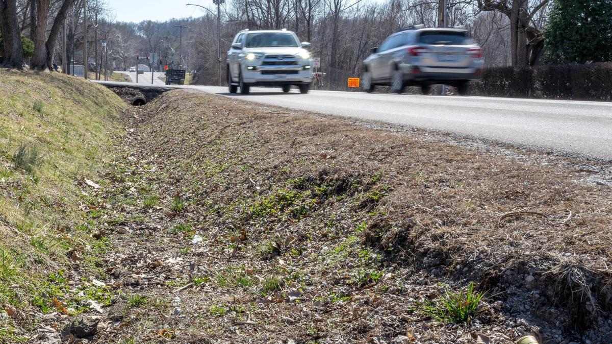 Vehicles pass a ditch along Northwest Waukomis Drive on Wednesday, March 12, 2025, in Northmoor.