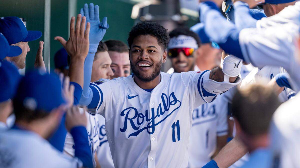 Kansas City Royals’ Maikel Garcia celebrates a home run with teammates in the dugout during the Royals’ 2024 home opener against the Minnesota Twins at Kauffman Stadium.
