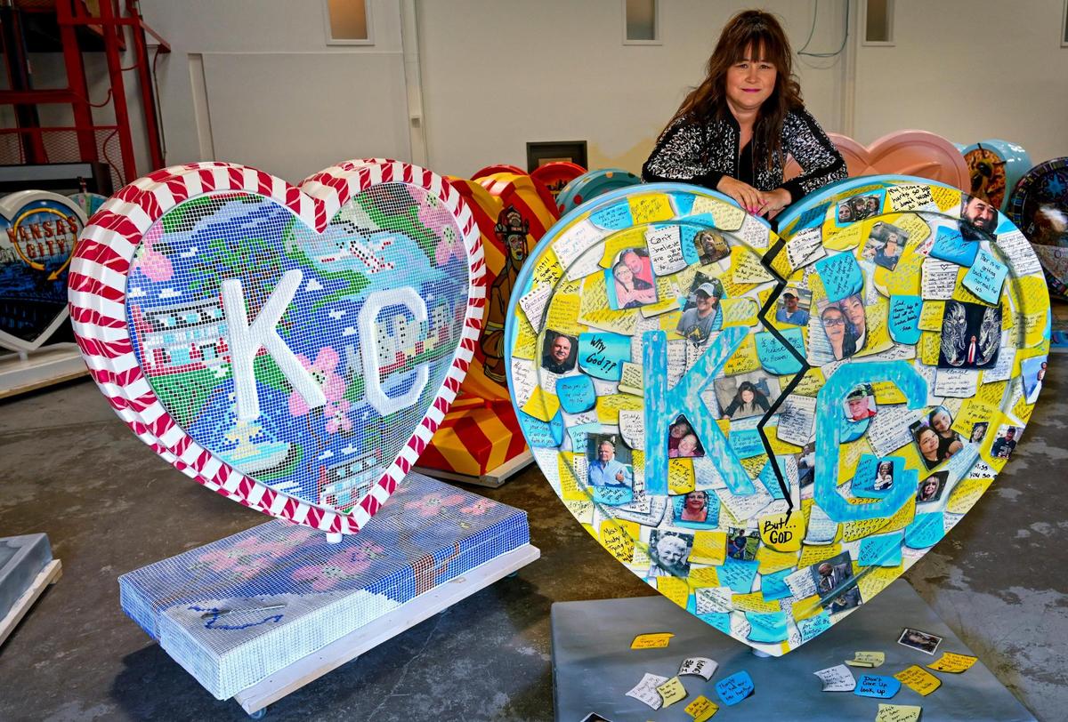 Artist Brooke Jiskra posed with her oversized heart adorned with photos and messages to those of died of COVID-19, including her sister. Jiskra was one of three artists on hand at Dimensional Innovations on Monday, Feb. 14, 2022 in Overland Park during a preview for the for the Parade of Hearts, an event that will display over 150 hearts created by local artists throughout the Kansas City area. The hearts will go on public display in mid-March.