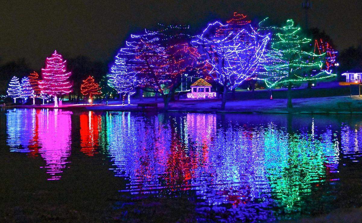 Holiday lights reflect off the lake on Dec. 6, 2022, at Sar-Ko-Par Trails Park in Lenexa.