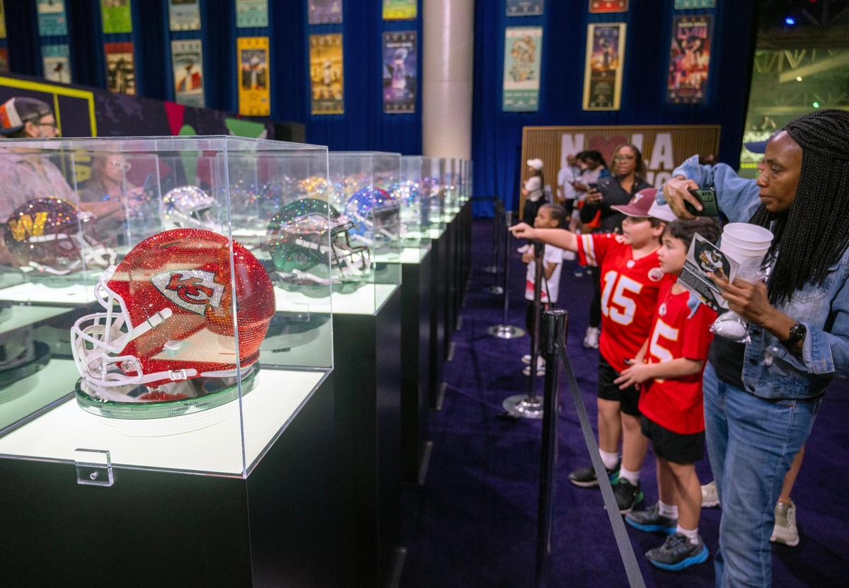 Visitors to the Super Bowl Experience took photos of the bedazzled football helmets, including one for the Kansas City Chiefs, at the Ernest N. Morial Convention Center on Thursday, Feb. 6, 2025, in New Orleans.