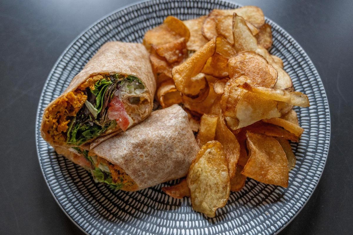 The Market Wrap is filled with sweet potato quinoa falafel, spring mix, tomatoes, feta cheese, cucumber dressing, red onions and hummus inside a whole wheat tortilla.
