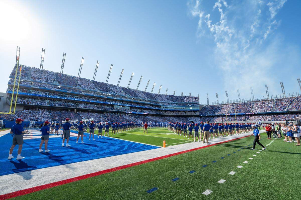 Cheerleaders and the school band line up on the field in David Booth Kansas Memorial Stadium prior to the Jayhawks game vs. the Fresno State Bulldogs on Saturday, Aug. 23, 2025, in Lawrence.