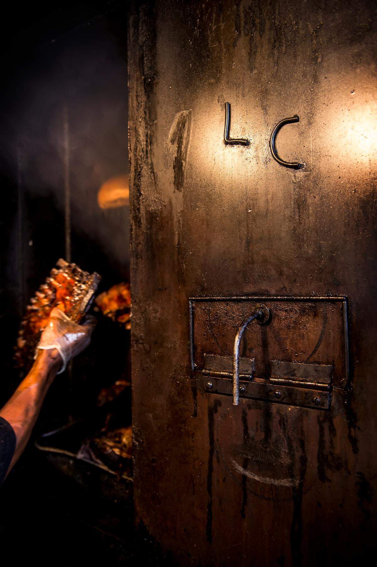 Lorenzo Pettis, pit master, pulled out a slab of cooked ribs from inside the smoker at LC’s Bar-B-Q at 5800 Blue Parkway in Kansas City, Mo.