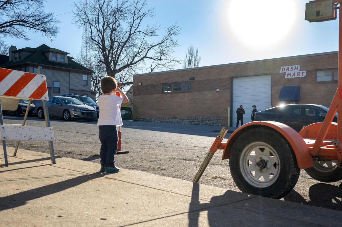 Sarah and John Wildman’s 3-year-old son observes DashMart from the front sidewalk of their home on Feb. 27 in Kansas City.