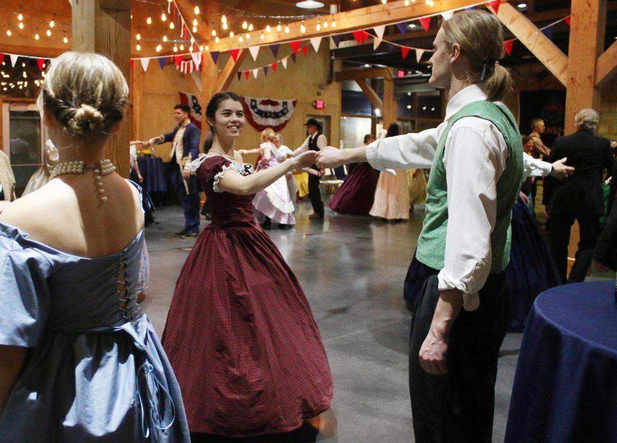 Lawrence residents Leilani Chun and Evan Johnson get in the swing of things during the 1860s dance party at the Mahaffie Stagecoach Stop and Farm Jan. 27.