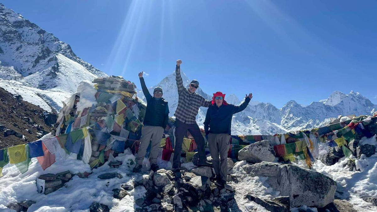 Dave and Dennis McClung are seen with their guide at South Base Camp at Mount Everest on Sunday, Oct. 19, 2025.