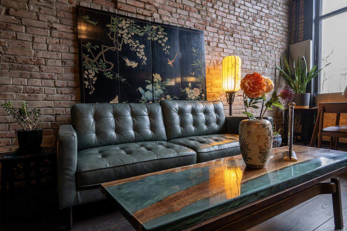 A lounge area featuring artwork and a small lamp is seen at Moon Bar KC on Tuesday, Dec. 16, 2025, in Kansas City.