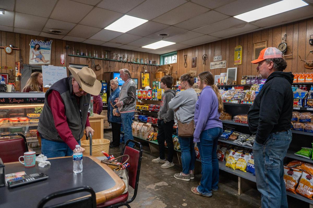 Guests wait in line for the night’s special: a pulled pork sandwich with chips for $7.99.