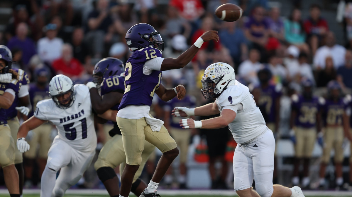 North Kansas City quarterback Mekhi Fields (No. 9) fires a pass while Kearney’s Konnar Dampier applies pressure during a 24-20 high school football win by the Bulldogs on Friday, Sept. 26, 2025.