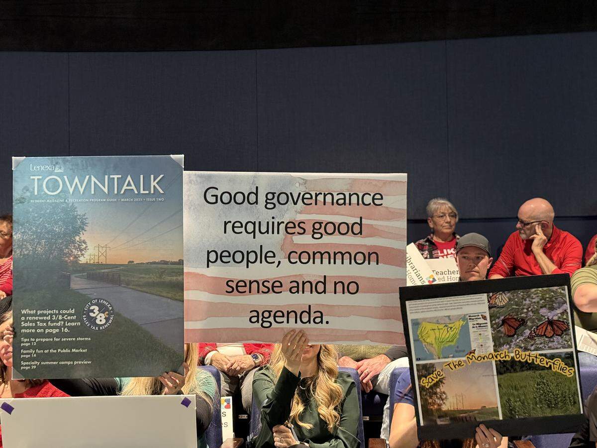 Signs residents held during the Tuesday, Feb. 18 Lenexa City Council meeting, to oppose Habitat for Humanity’s proposal to build 50 affordable homes. 