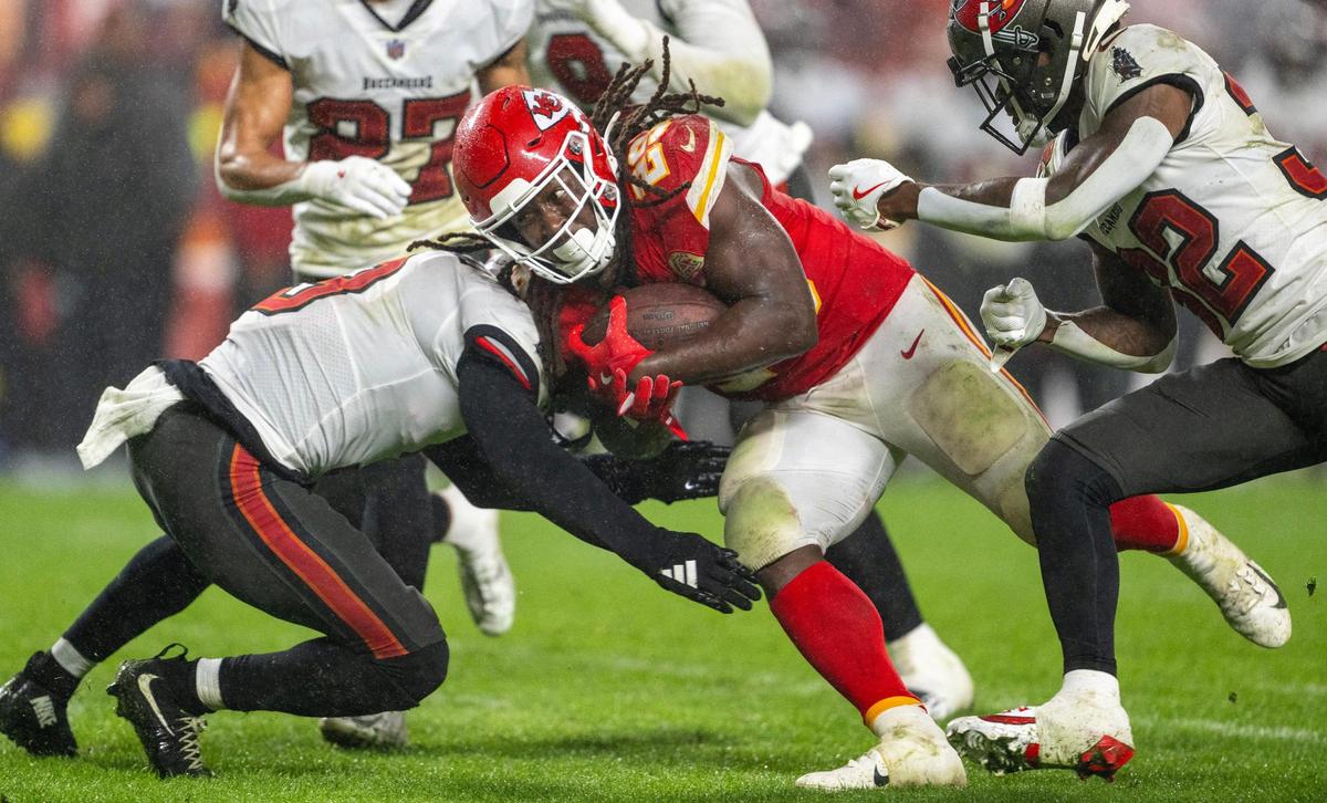 Kansas City Chiefs running back Kareem Hunt (29) is tackled Tampa Bay Buccaneers safety Jordan Whitehead (3) in the third quarter during an NFL game on Monday, Nov. 4, 2024, at GEHA Field at Arrowhead Stadium.