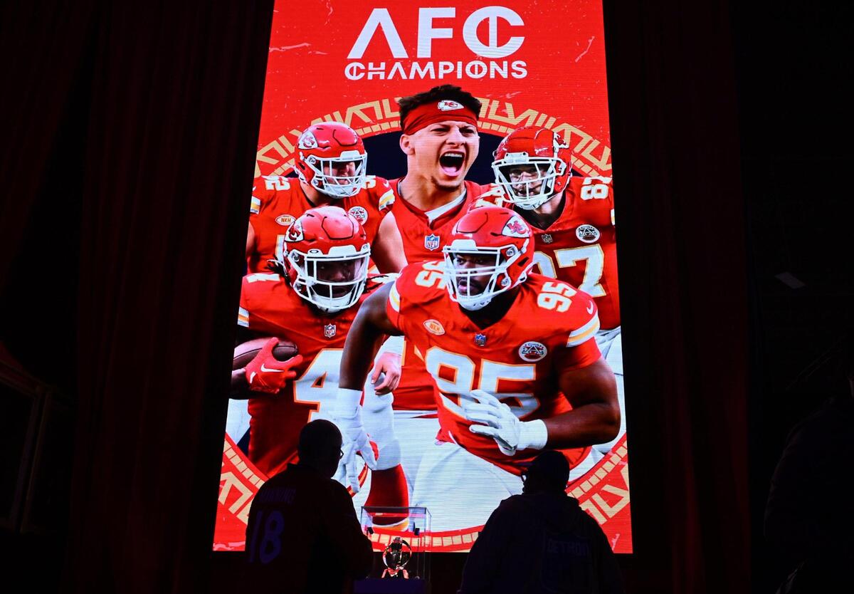 Football fans watched a montage of the Kansas City Chiefs as they viewed the Lamar Hunt Trophy at the Super Bowl Experience, on Thursday, Feb. 8, 2024, in Las Vegas, Nevada.