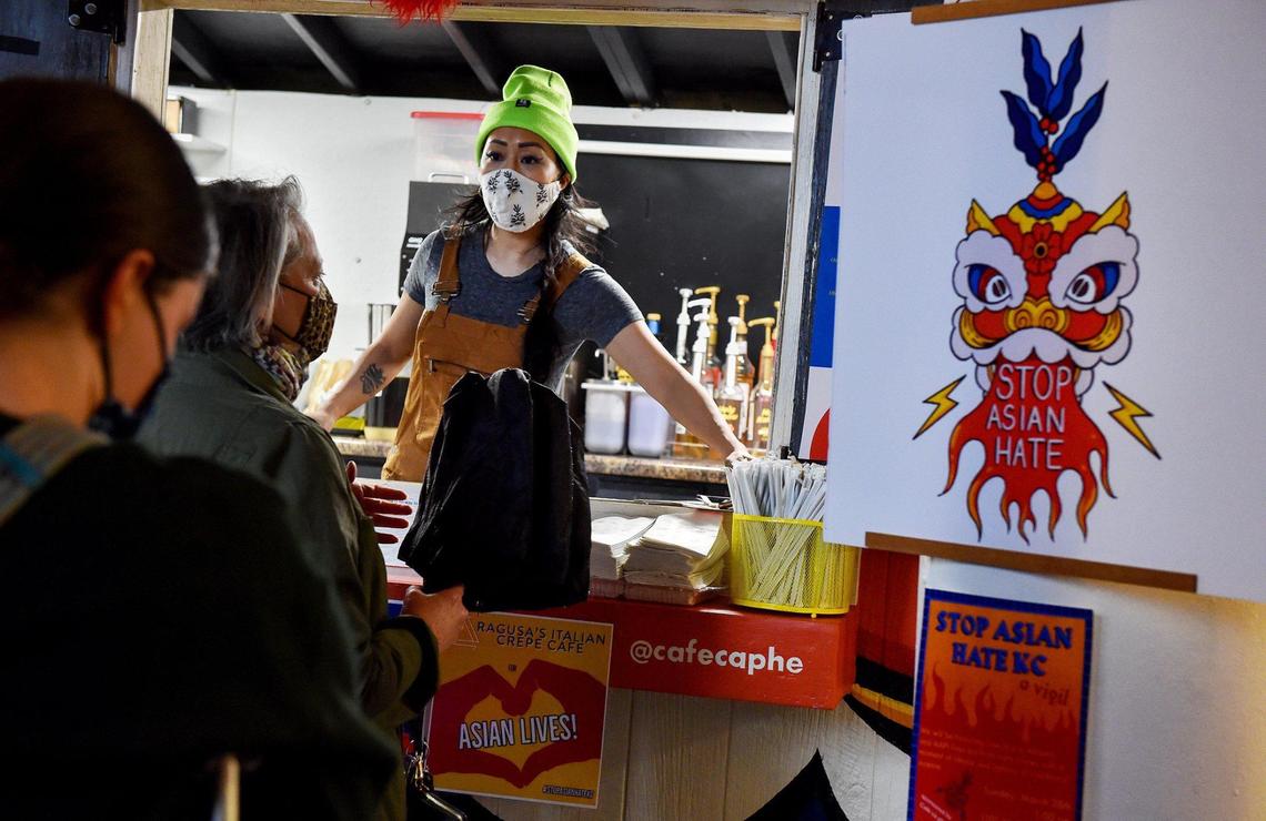 Jackie Nguyen, owner of Cafe Cà Phê, helps a customer at her mobile coffee shop Thursday in the West Bottoms. A vigil to honor the eight people killed in Georgia this month, most of them Asian women, will be held outside her cafe on Sunday.