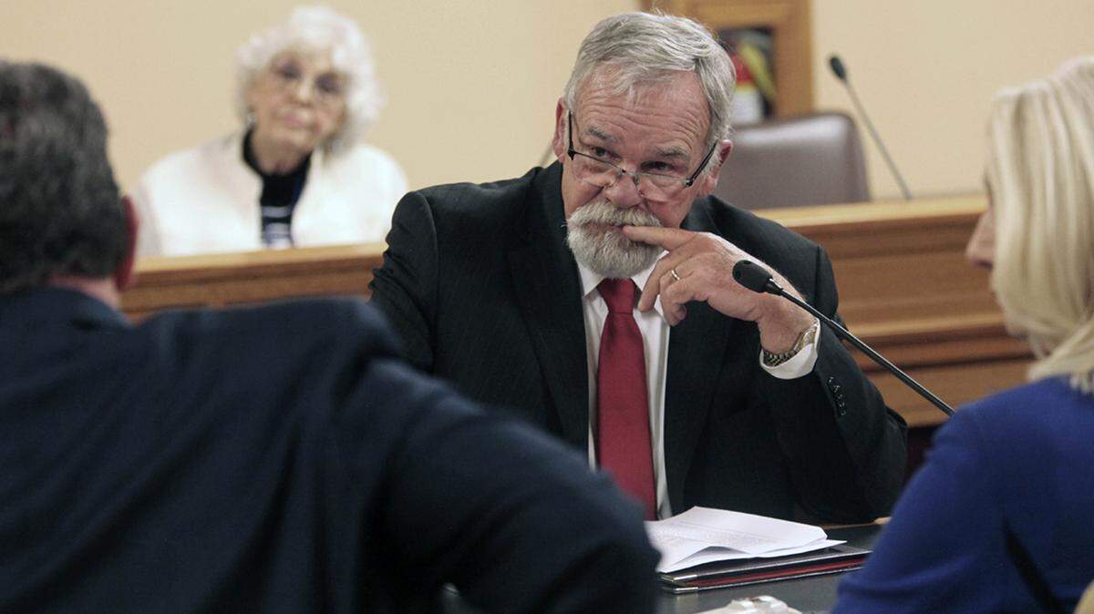 Kansas state Rep. John Barker, R-Abilene, ponders a point during negotiations between the House and Senate on legislation dealing with federal COVID-19 vaccine mandates, Monday, Nov. 22, 2021, at the Statehouse in Topeka, Kan. Barker is the House’s lead negotiator on proposals for financially protecting workers who refuse to get the shots.