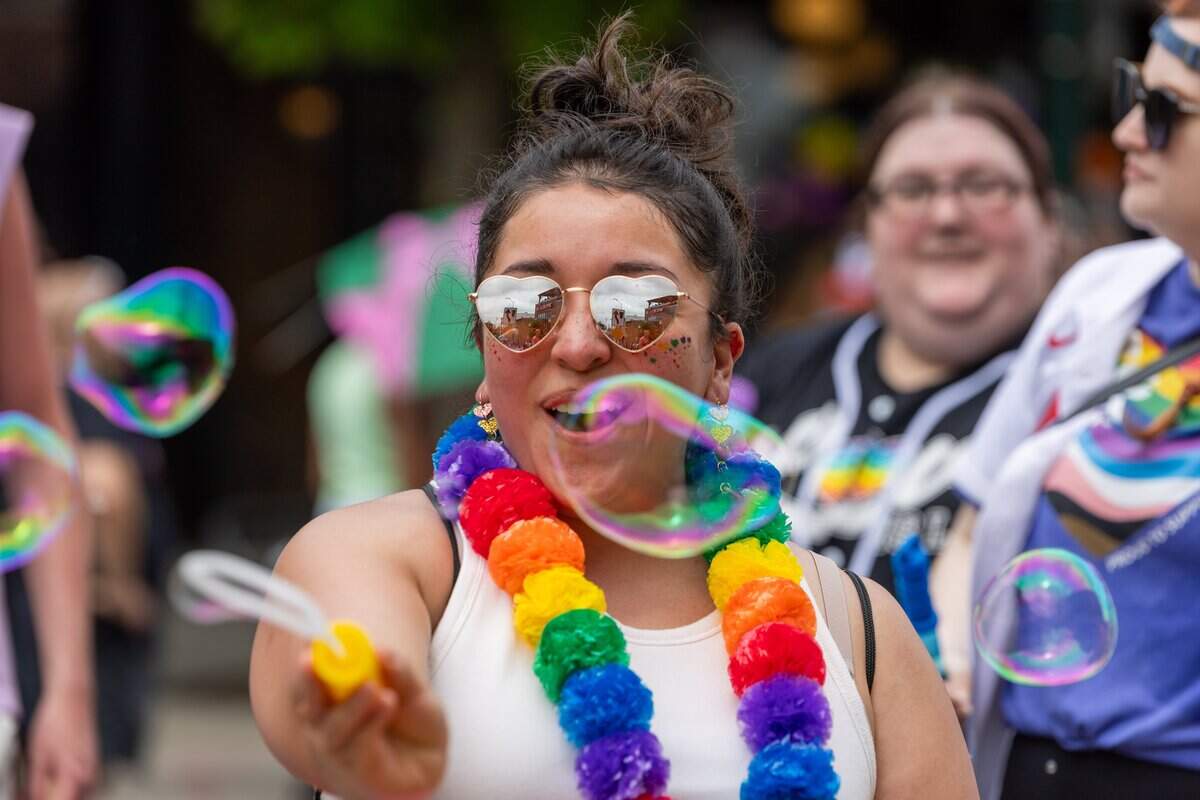 Parade attendee blow bubbles while they walk Kansas City's Annual Pride Parade at Westport Rd on Saturday, June 6, 2026.