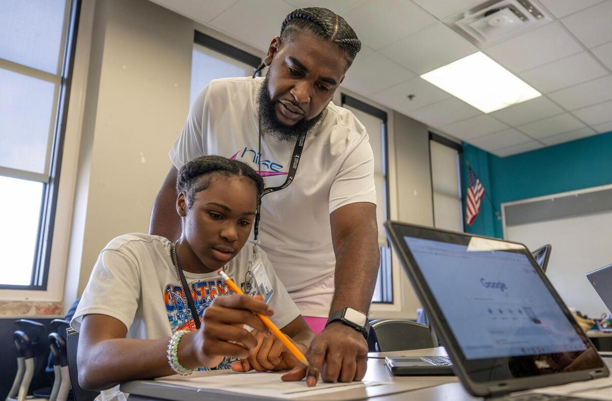 Vincent Gunnels helps a student with their assignment during summer school at Central Middle on Monday, June 16, 2025, in Kansas City.