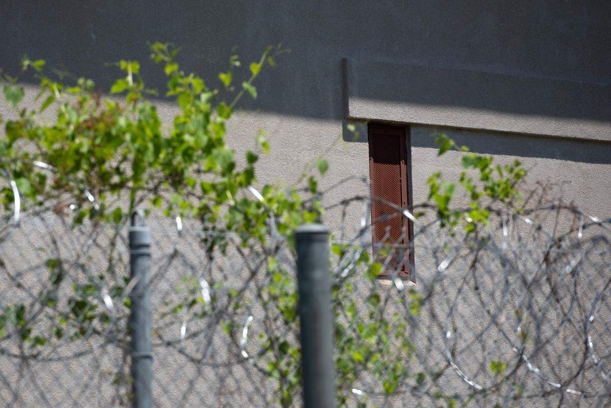 Narrow windows covered by a grate are visible from outside the jail complex.