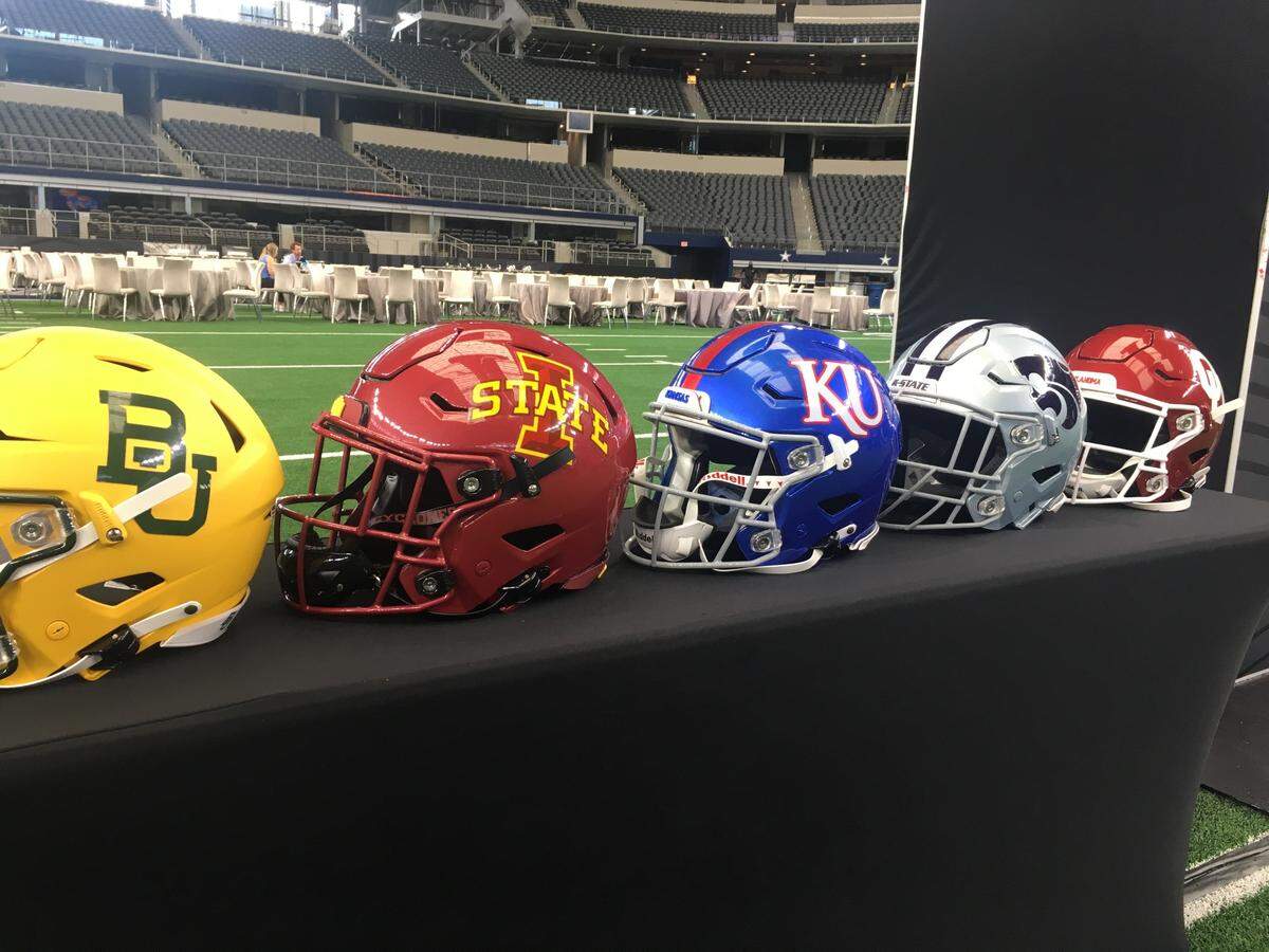 Several football helmets were on display at the 2021 Big 12 football media days in Arlington, Texas. Oklahoma and Texas announced the first step toward leaving the conference a few days later.