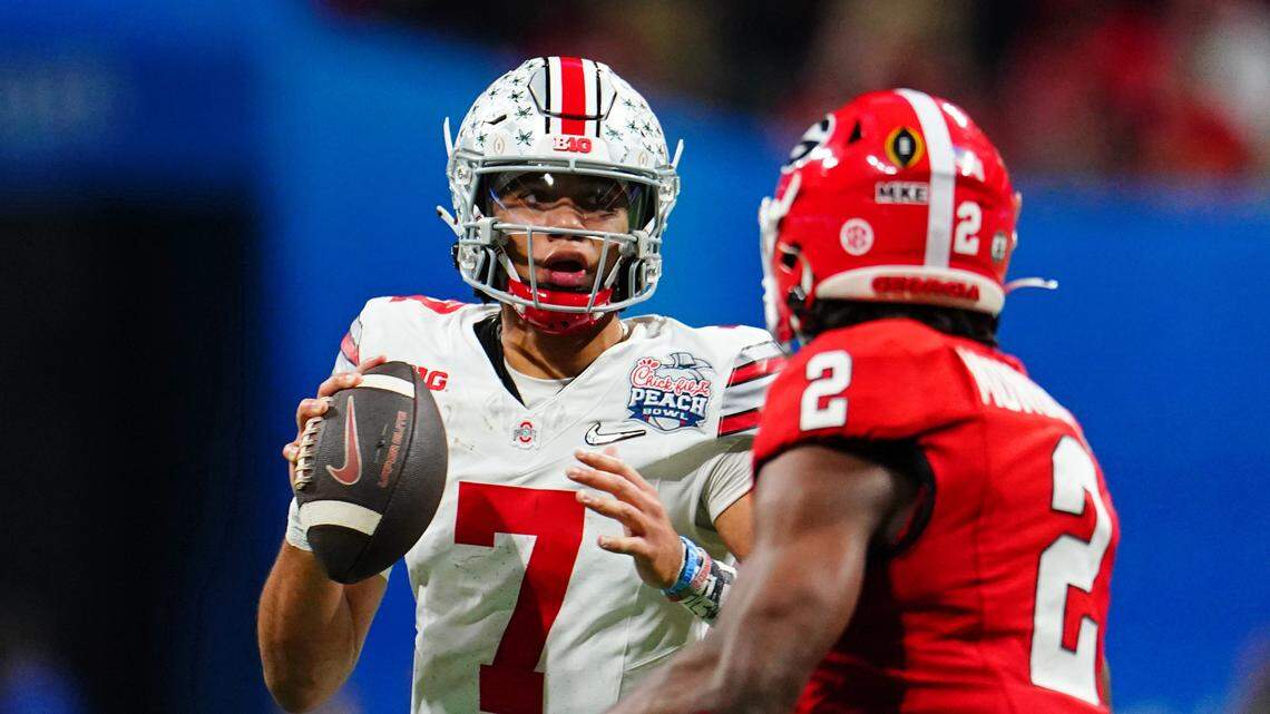 Ohio State Buckeyes quarterback C.J. Stroud (7) looks for a receiver against the Georgia Bulldogs during the third quarter of the 2022 Peach Bowl at Mercedes-Benz Stadium.