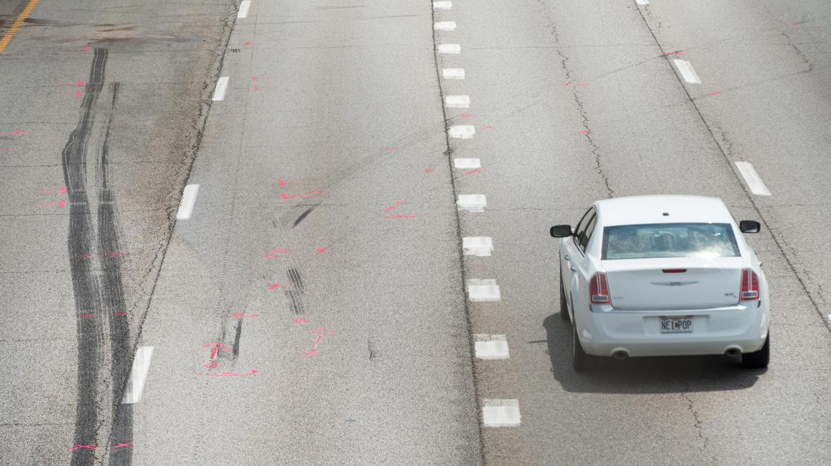 Tire marks and vehicle fluids cover the southbound lanes of I-435 at Bannister Road after a police chase ended in a crash on Tuesday, July 25, 2023, in Kansas City. Officers were pursuing an allegedly stolen vehicle when the car was rear ended by a semi-truck and lost control.