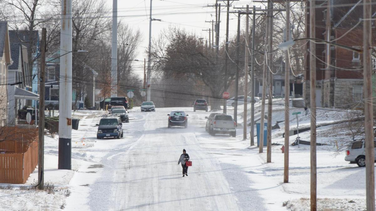 A woman walked down a snowy street in Kansas City, Kansas, amid frigid temperatures this past week.