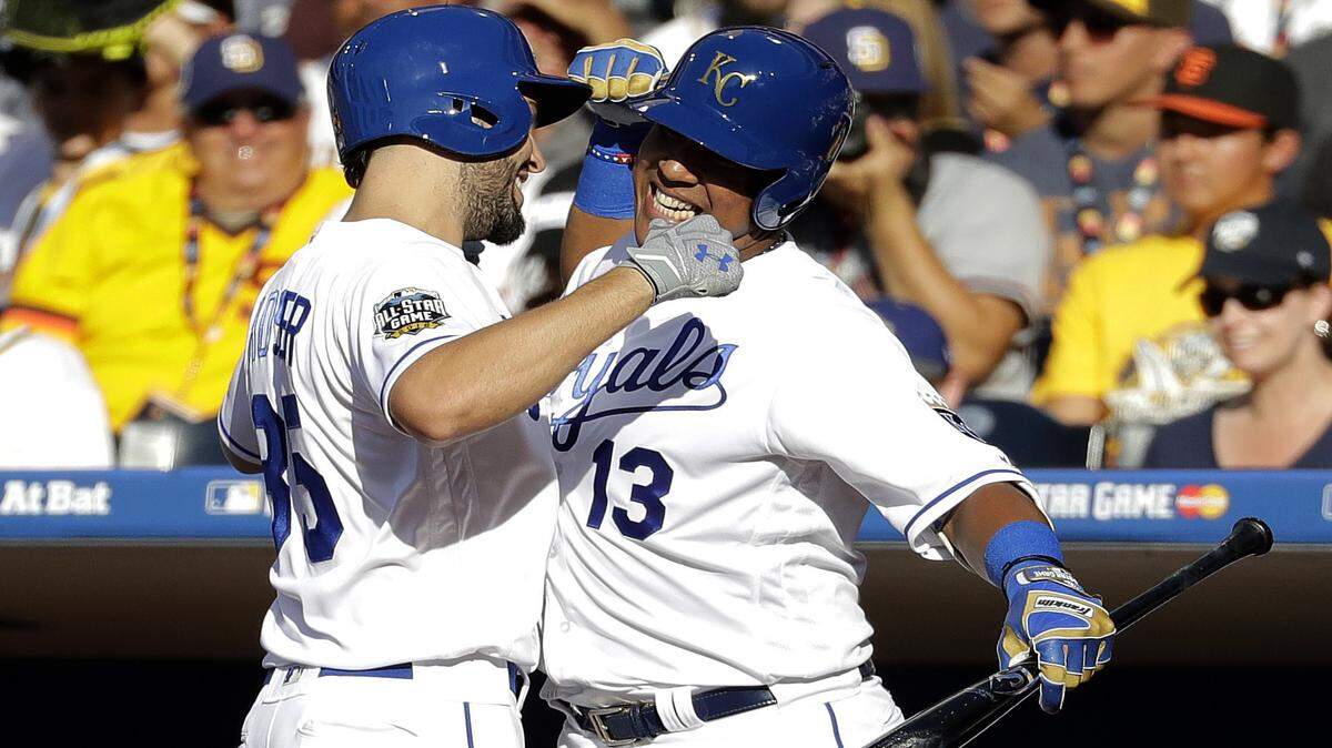 American League's Eric Hosmer, of the Kansas City Royals, left, greets teammate Salvador Perez, of the Kansas City Royals, after hitting a solo home run against the National League during the second inning of the MLB baseball All-Star Game, Tuesday, July 12, 2016, in San Diego. 