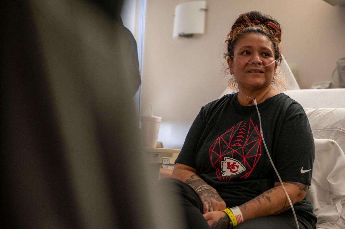 Lisa Sidenstick sits on her hospital bed as she waits for an oxygen tank to be delivered so that she can go home from North Kansas City Hospital on Wednesday, March 30, 2022. Sidenstick is a KCPD officer who has been battling COVID-19 for the past few months and is now able to leave.