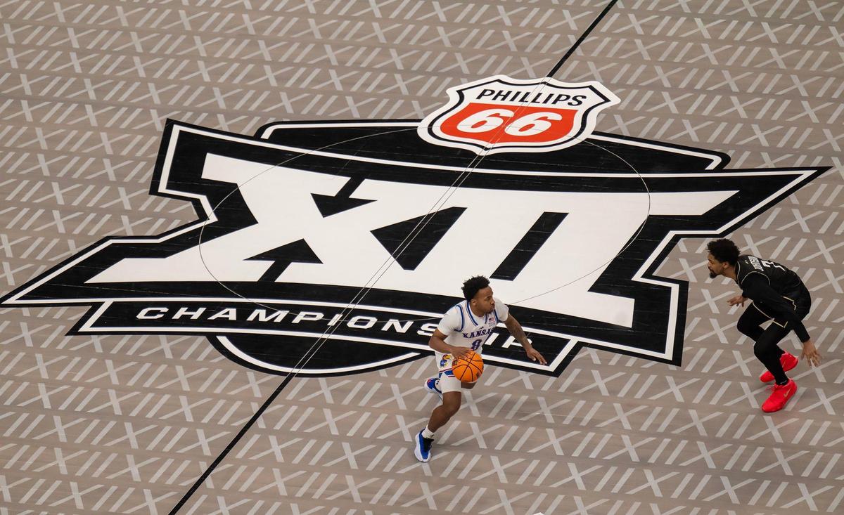 Kansas Jayhawks guard David Coit (8) dribbles as UCF Knights guard Darius Johnson (3) defends in the first half at the Big 12 Tournament at T-Mobile Center on Wednesday, March 12, 2025, in Kansas City.