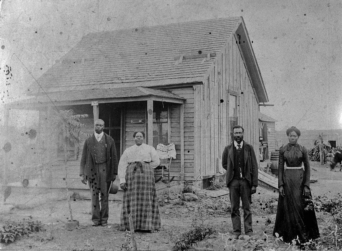 This undated photos shows the occupants of an early homestead in Nicodemus, Kansas.