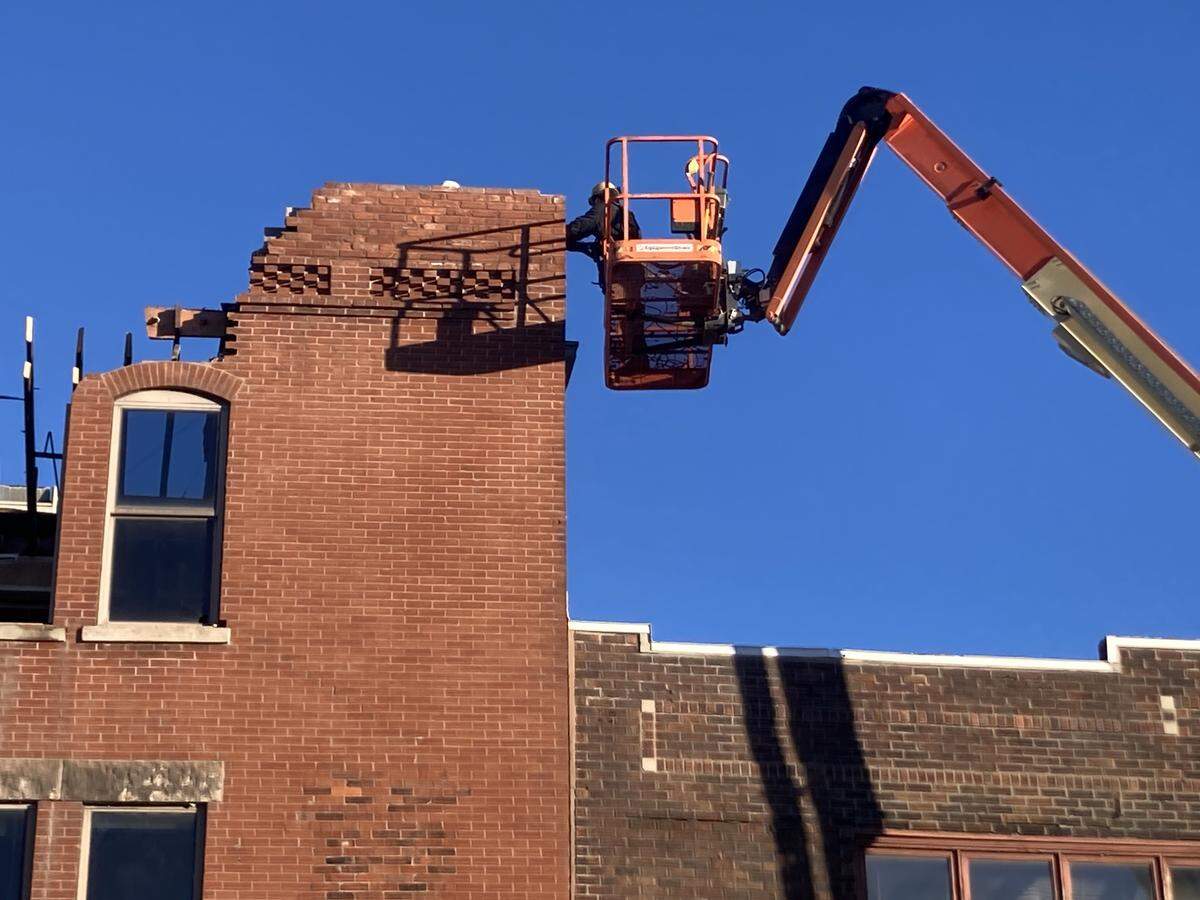 Workers slowly deconstruct the 1888 Jeserich building at the corner of 31st and Main streets on the morning of Jan. 14.