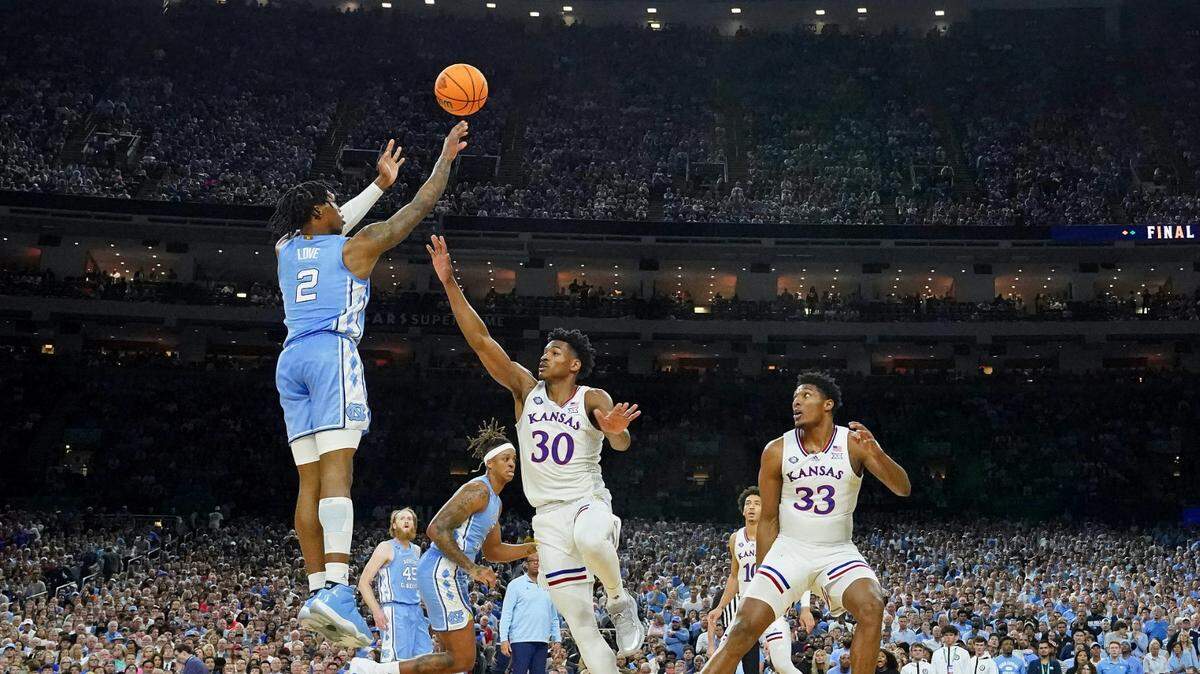 North Carolina guard Caleb Love (2) shoots a three-point basket against Kansas guard Ochai Agbaji (30) during the 2022 NCAA men’s basketball championship game at Caesars Superdome in New Orleans on April 4, 2022.