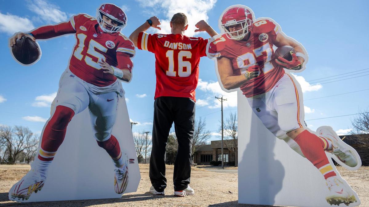 Philip Rineberg, a Kansas City Chiefs fan, proudly displays his Len Dawson jersey as he poses for a photo with life-size cutouts of Kansas City Chiefs quarterback Patrick Mahomes and tight end Travis Kelce on Monday, Feb. 5, 2024, in Guymon, Okla.