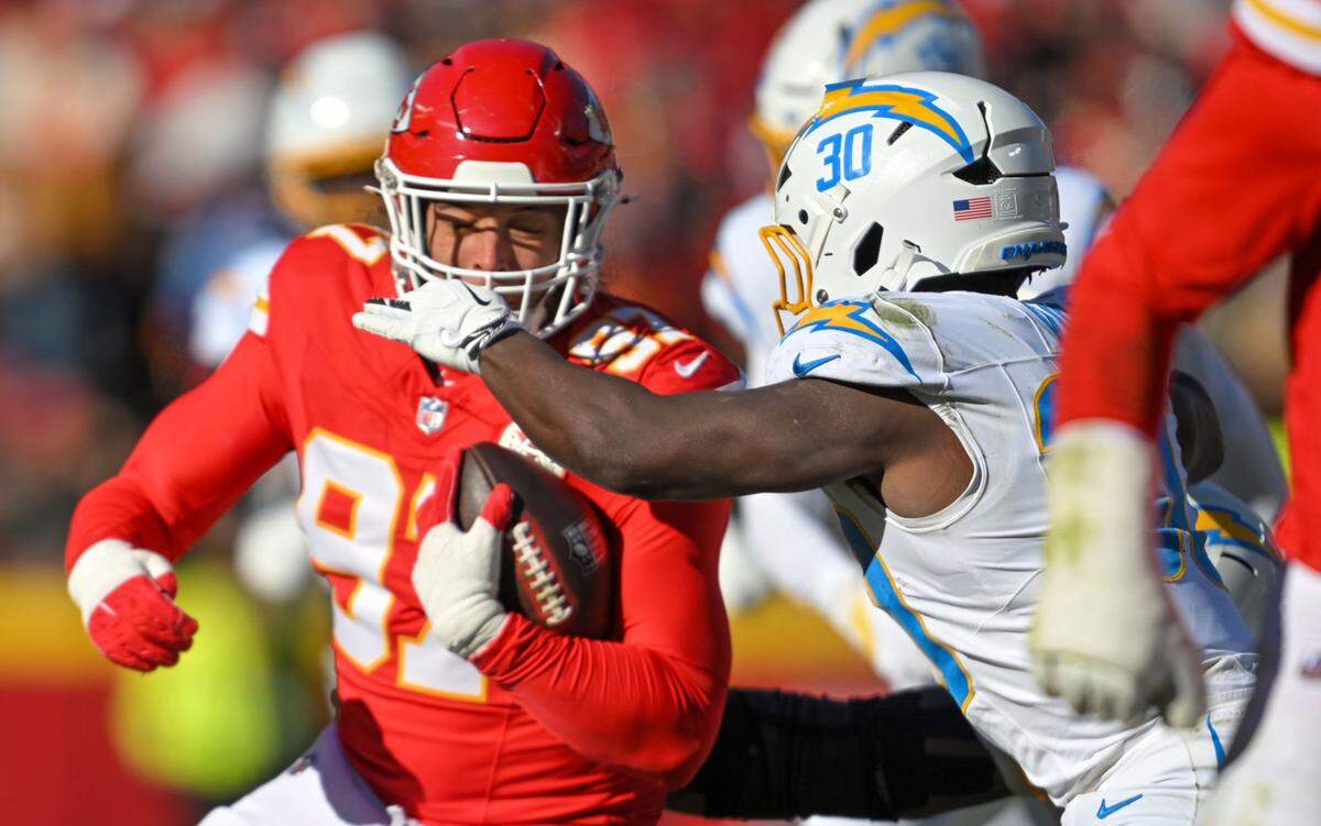 Kansas City Chiefs defensive end Ashton Gillotte (97) catches an interception in the second quarter against the LA Chargers at GEHA Field at Arrowhead Stadium on Sunday, Dec. 14, 2025.