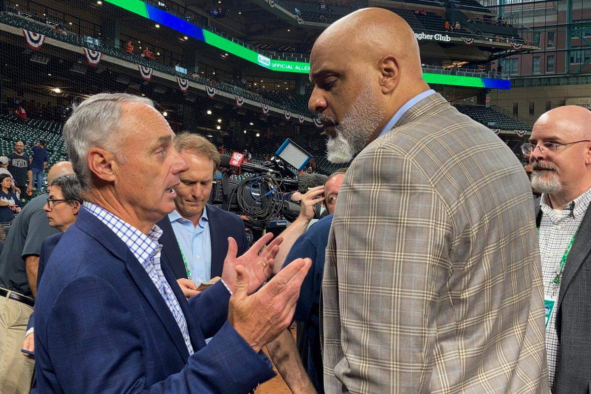 MLB commissioner Rob Manfred, left, and Major League Baseball Players Association director Tony Clark speak before Game 1 of last fall’s World Series between the Houston Astros and Atlanta Braves.