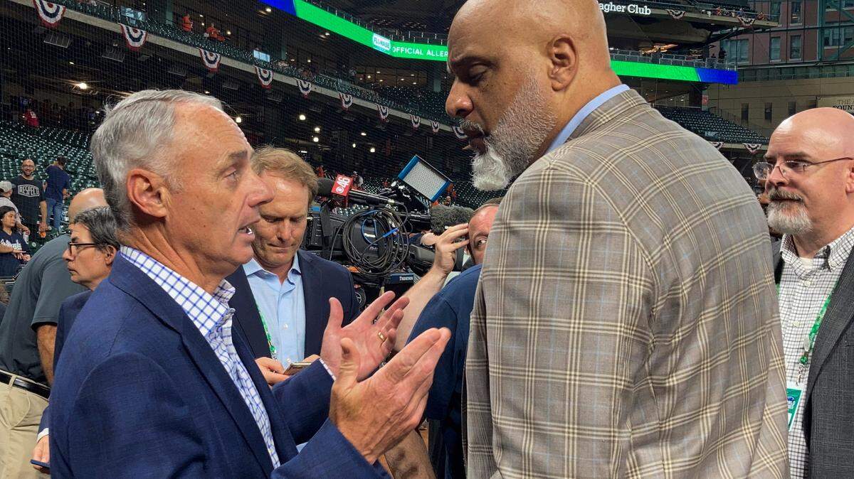 FILE - Baseball Commissioner Rob Manfred, left, and Major League Baseball Players Association executive director Tony Clark speak before Game 1 in baseball’s World Series between the Houston Astros and the Atlanta Braves, Oct. 26, 2021, in Houston. A five-year contract between MLB and the Major League Baseball Players Association expires at 11:59 p.m. EST on Dec. 1, 2021. (AP Photo/Ron Blum, File)