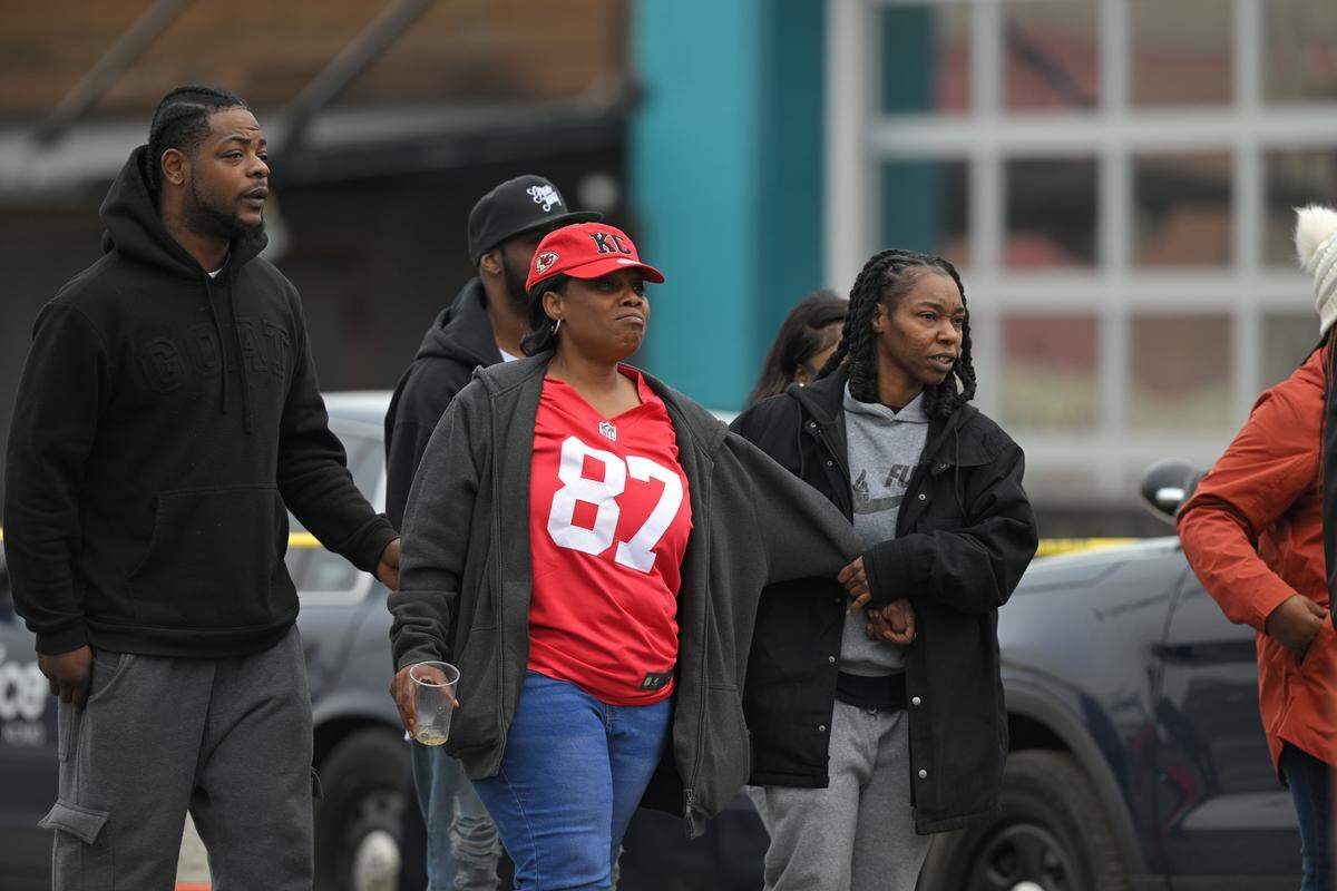 People gather outside the scene of a fatal shooting at a Kansas City nightclub near 28th Street and Southwest Boulevard on Sunday morning, Feb. 15. Two people were killed and another two were injured in the shooting.