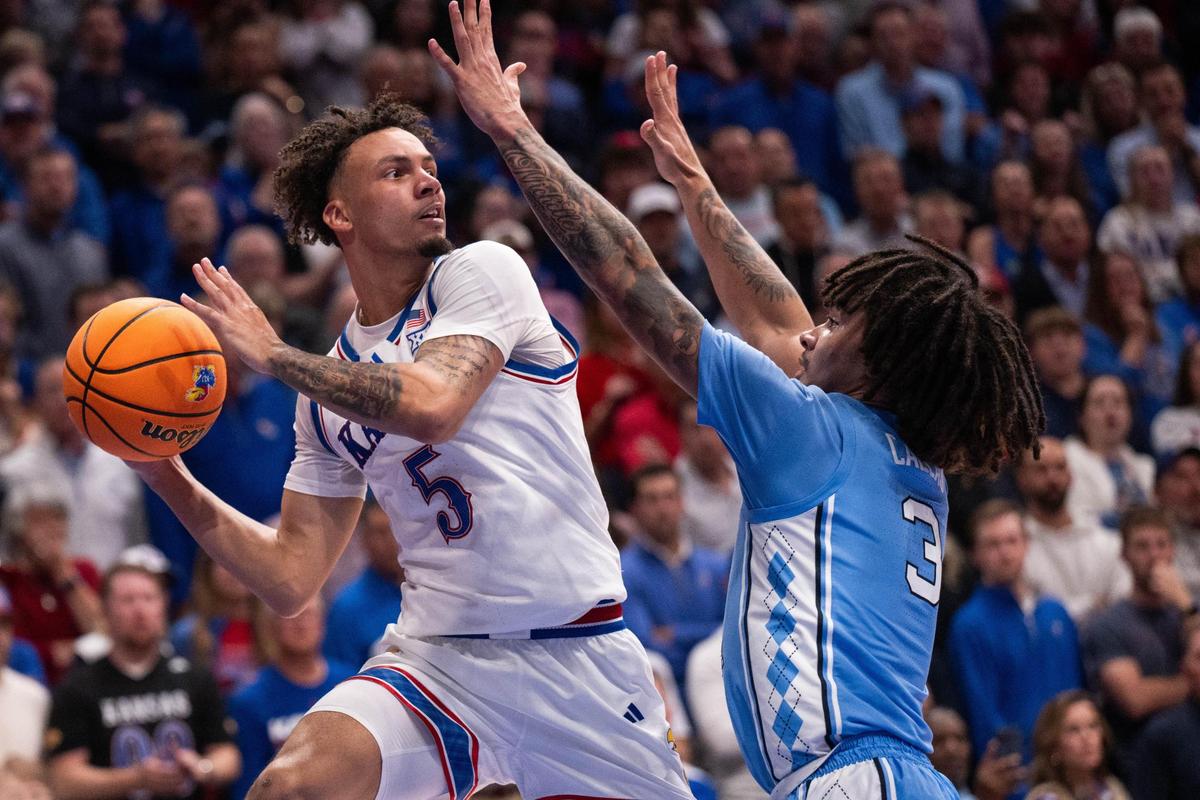 Kansas Jayhawks guard Zeke Mayo looks to pass the ball across court during the second half of the Jayhawks game vs. the North Carolina Tar Heels at Allen Fieldhouse on Friday, Nov. 8, 2024.
