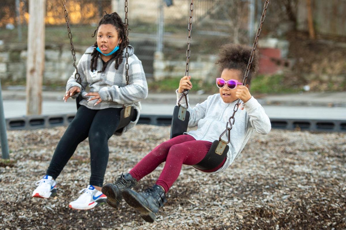 Queen Tye, 9, left, and Empress Tye, 7, granddaughters of Karen Daniels, play on the swings at the Boston Daniels Park on Tuesday, Feb. 23, 2021. The park has deteriorated over the years since it was dedicated to Boston Daniels.