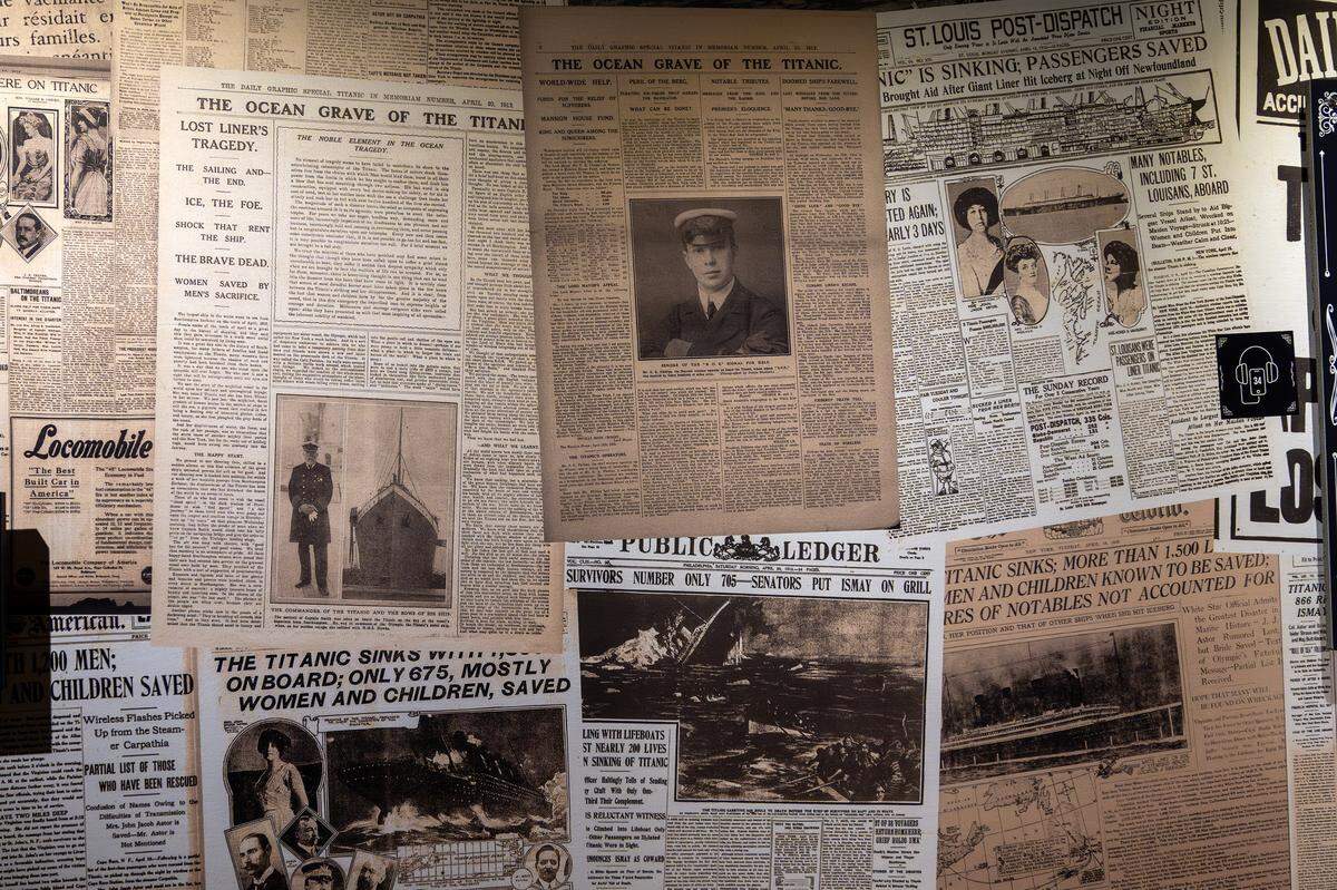 A collage of newspapers covering the Titanic sinking, including a copy from the St. Louis Post-Dispatch, is displayed on a wall at the Titanic: An Immersive Voyage exhibit at Union Station on Thursday, Nov. 6, 2025, in Kansas City.