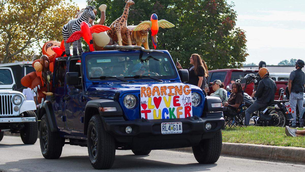 A Jeep is seen with a sign that reads “Roaring with love for Tucker” at a parade on Oct. 11, 2025.