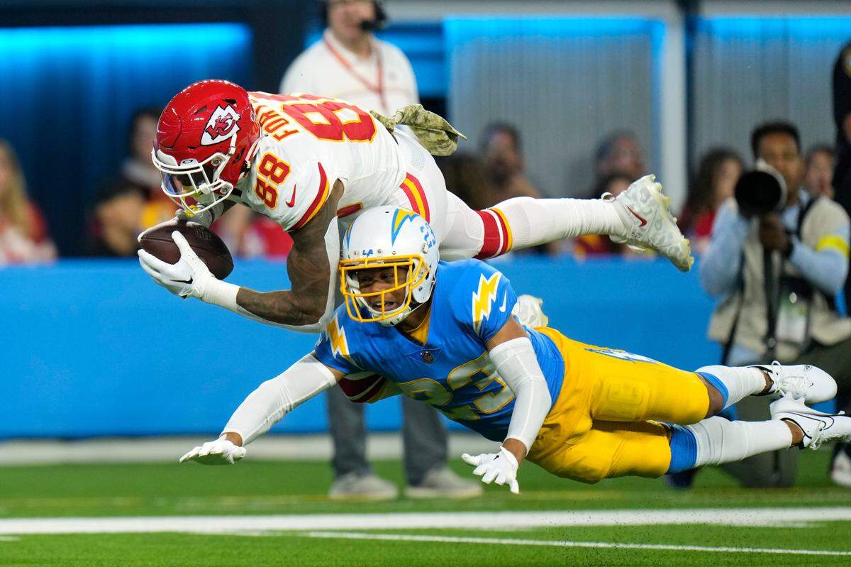 Kansas City Chiefs tight end Jody Fortson, top, makes a catch as Los Angeles Chargers cornerback Bryce Callahan defends during the first half of an NFL football game Sunday, Nov. 20, 2022, in Inglewood, Calif.