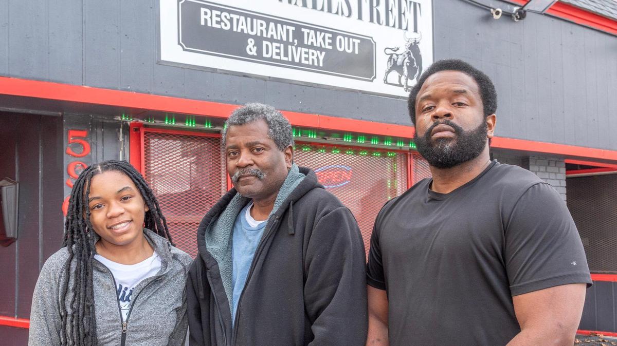 Treazhur Carson, her grandfather Sheldon Carson Sr., and father Sheldon Carson at the new Black Wall Street.