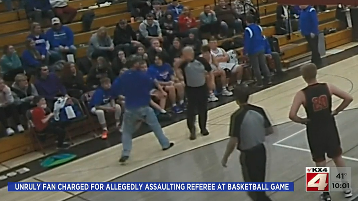 A man was charged after he threw a bag of popcorn at a referee and grabbed him during a high school basketball game, Minnesota cops say.