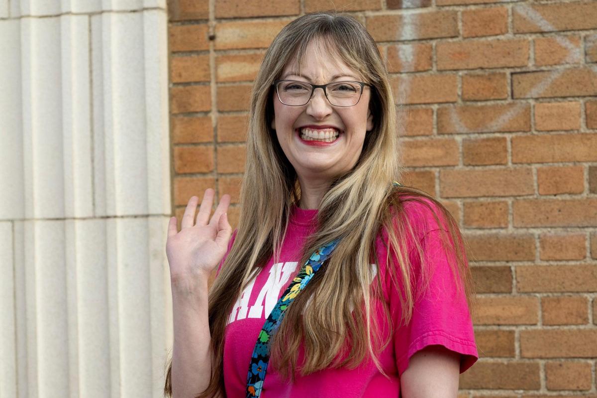 Miranda Hayley of Topeka, Kansas, waves while waiting in line to attend Trisha Paytas’s The Eras of Trish Tour at Uptown Theater on Thursday, May 29, 2025, in Kansas City.