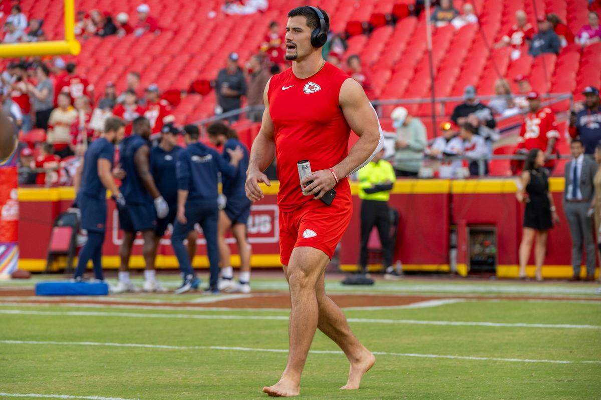 Chiefs linebacker Drue Tranquill gets ready for a game while listening to music through headphones at GEHA Field at Arrowhead Stadium.