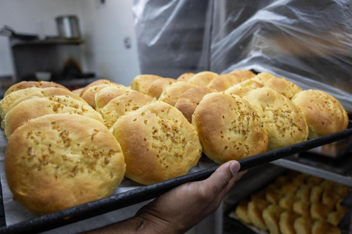 A sheet tray of onion rolls await deli meats and cheeses at M & M Bakery and Delicatessen.