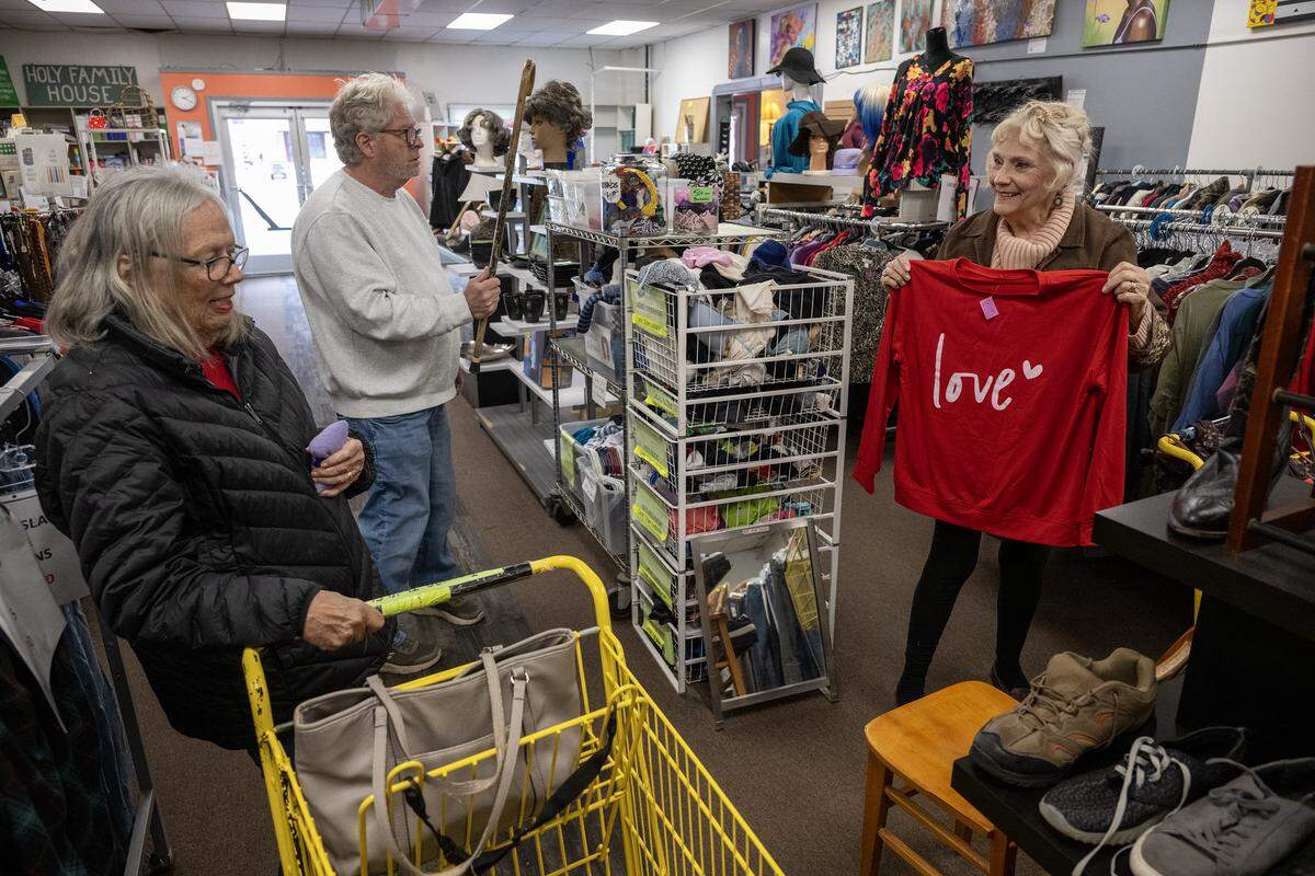 Chuck Wurth, one of the partners of Troost39 Thrift Store, was looking for the owner of a cane as sisters Mary Towse of Bonner Springs, left, and her sister, Judy Roberts of Raytown, shopped on Thursday, Jan. 15 2026, in Kansas City. The sisters said they are regulars at the shop in Kansas City. 