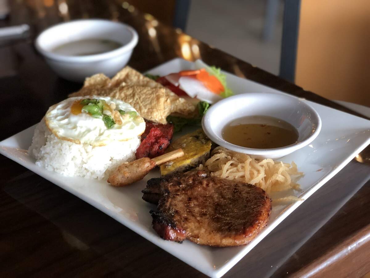 Broken Rice’s specialty plate pairs a mound of broken rice with a juicy pork chop and a variety of sides such as a fried egg, egg cake, crispy pork skin, grilled pork sausage and a shrimp ball wrapped around sugarcane.