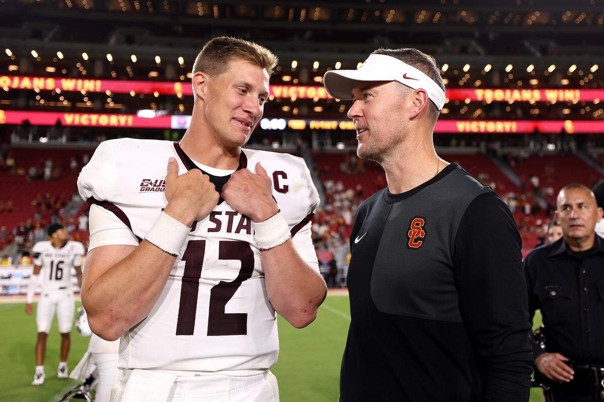Head coach Lincoln Riley of the USC Trojans speaks to Jacob Clark #12 of the Missouri State Bears after the game at United Airlines Field at the Los Angeles Memorial Coliseum on August 30, 2025 in Los Angeles.